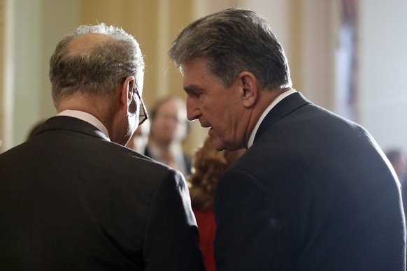 FILE - In this May 2, 2017, file photo, Sen. Joe Manchin, D-W.Va., right, speaks to then-Senate Minority Leader Charles Schumer, D-N.Y. during a news conference on Capitol Hill in Washington. Schumer  ...