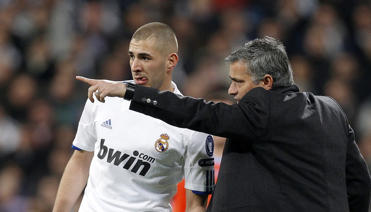 Real Madrid's coach Jose Mourinho from Portugal, right gives instructions to Karim Benzema from France during a Round of 16, 2nd leg Champions League soccer match against Lyon at the Santiago Ber ...