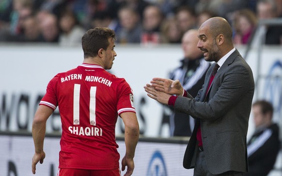 Bayern head coach Pep Guardiola of Spain, right, speaks to Bayern&#039;s Xherdan Shaqiri of Switzerland during the German Bundesliga soccer match between VfL Wolfsburg and Bayern Munich in Wolfsburg,  ...