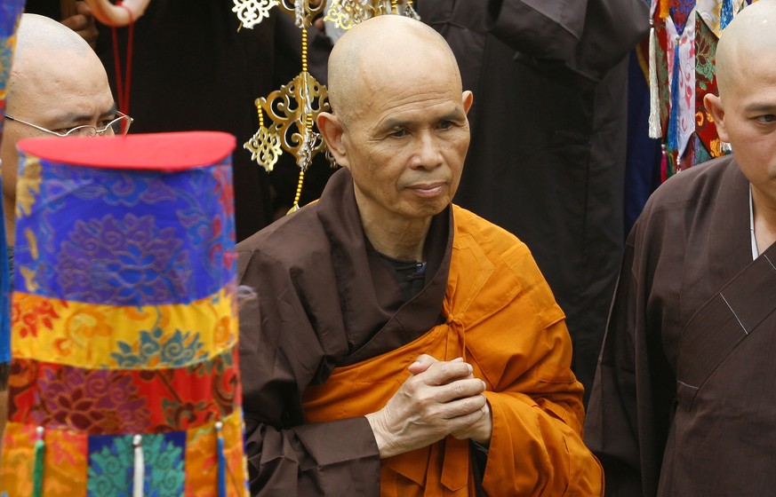 FILE - Vietnamese Zen master Thich Nhat Hanh, center, arrives for a great chanting ceremony at Vinh Nghiem Pagoda in Ho Chi Minh City, Vietnam on March 16, 2007. Zen Buddhist monk Thich Nhat Hanh, who ...