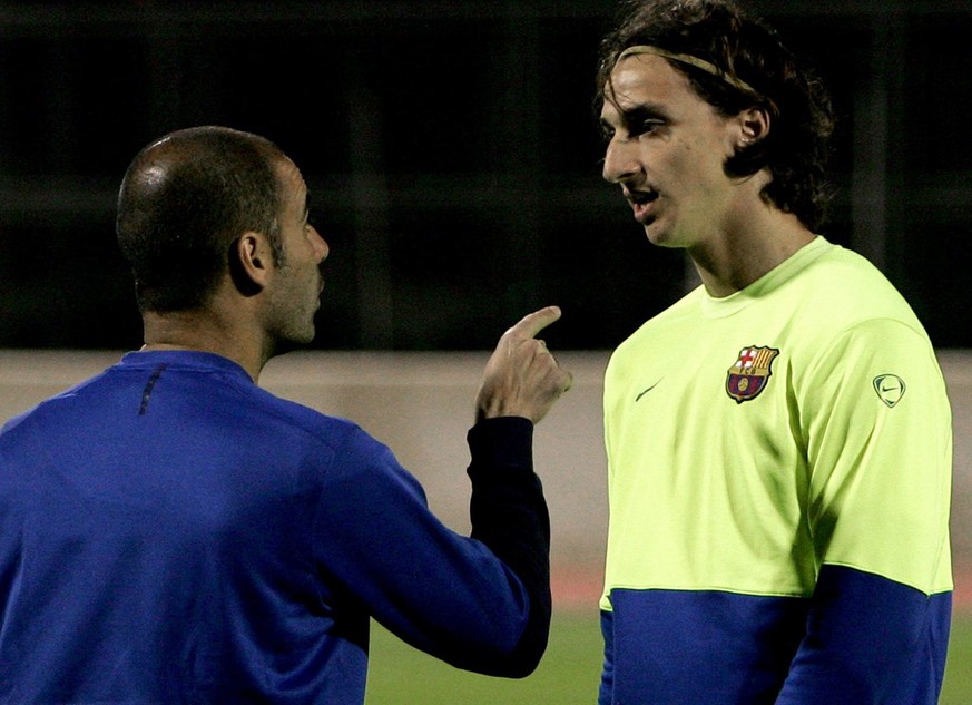 epa02992510 (FILE) Photo dated 18 December 2009 shows Zlatan Ibrahimovic (R) of FC Barcelona receiving istructions from his coach Pep Guardiola (L) during a training session at Army stadium in Abu Dha ...