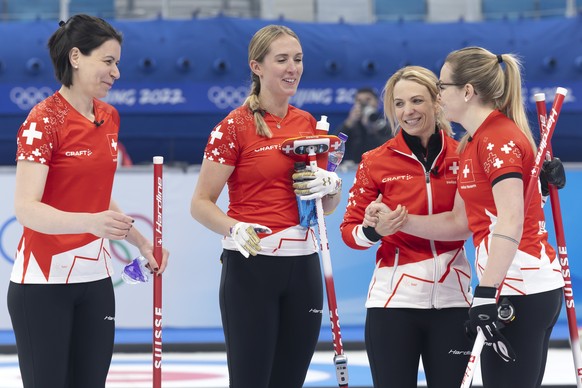 Switzerland skip Silvana Tirinzoni, 2nd right, and her teammates Esther Neuenschwander, left, Melanie Barbezat, 2nd left, and Alina Paetz, right, celebrate after defeating the South Korea team during  ...