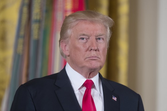 epa06119190 US President Donald J. Trump listens to the reading of the citation before awarding the Medal of Honor to US Army medic and Vietnam War veteran James McCloughan (not pictured), during a ce ...