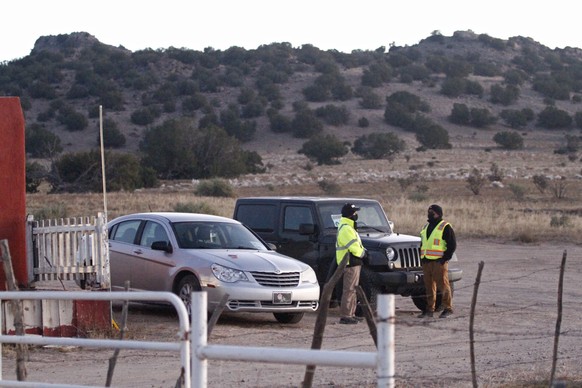 Security stands at the entrance to a film set where police say actor Alec Baldwin fired a prop gun, killing a cinematographer, is seen outside Santa Fe, New Mexico, Friday, Oct. 22, 2021. The Bonanza  ...