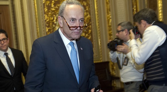 Sen. Charles Schumer, D-N.Y., walks to the chamber after a closed meeting with fellow democrats on Capitol Hill, Friday, Jan. 19, 2018, in Washington. (AP Photo/Jose Luis Magana)