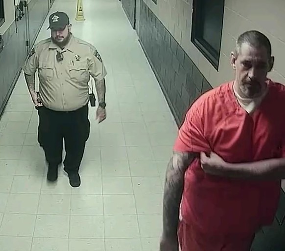 epa09922559 An undated handout surveillance image made available by the Lauderdale County Sheriff&#039;s Office on 02 May 2022 shows inmate Casey Cole White (R), who along with Lauderdale County Assis ...