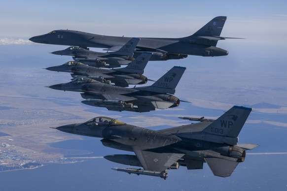 epa10476932 A handout photo made available by the South Korean Defense Ministry shows U.S Air force B-1B and F-16 aircrafts during a joint air drill after North Korea&#039;s missile launch, in South K ...