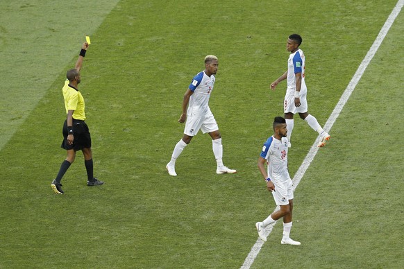 Panama's Edgar Barcenas, top right, is shown a yellow card by referee Janny Sikazwe, left, from Zambia during the group G match between Belgium and Panama at the 2018 soccer World Cup in the Fisht Sta ...