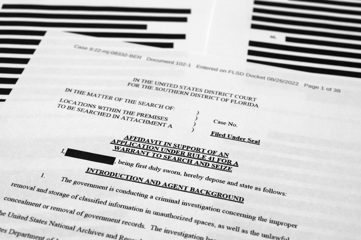 Pages from the affidavit by the FBI in support of obtaining a search warrant for former President Donald Trump's Mar-a-Lago estate are photographed Friday, Aug. 26, 2022. U.S. Magistrate Judge Br ...