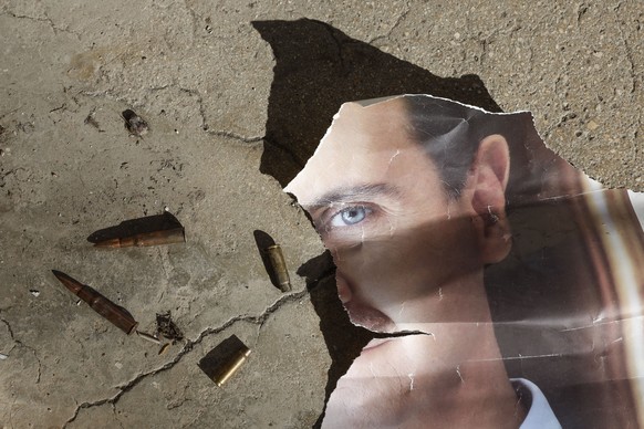 epa12241144 (FILE) - A portrait of the former Syrian president Bashar al-Assad on the ground at the Mezzeh Air Base on the outskirts of Damascus, Syria, 16 December 2024 (reissued 16 July 2025). Basha ...
