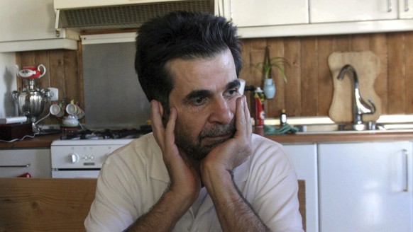 FILE - Iranian filmmaker Jafar Panahi, takes a moment at his home after he was freed from jail, in Tehran, Iran, on May 25, 2010. Acclaimed Iranian director Jafar Panahi was released on bail Friday, F ...