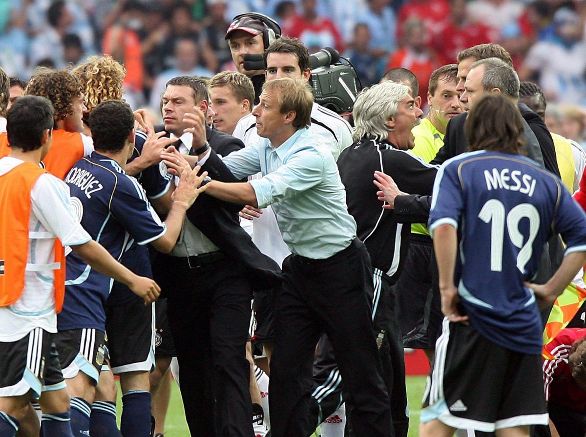 German coach Juergen Klinsmann (C) struggles with Argentinian players during the quarter final of the 2006 FIFA World Cup between Germany and Argentina in the Olympic Stadium in Berlin, Germany, Frida ...
