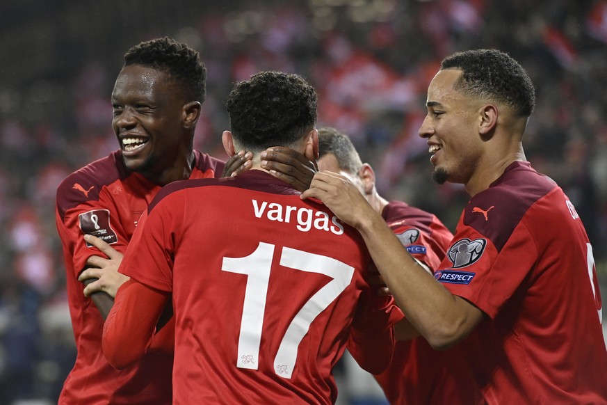 Switzerland's midfielder Ruben Vargas, center, celebrates his goal after scoring the 2 - 0 with Switzerland's defender Denis Zakaria, left, and Switzerland's forward Noah Okafor, right, ...