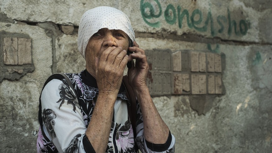 epa10041158 A woman reacts near a destroyed apartment building after shelling at a residential area in Mykolaiv, southern Ukraine, 29 June 2022. The Head of the Mykolaiv Regional Military Administrati ...