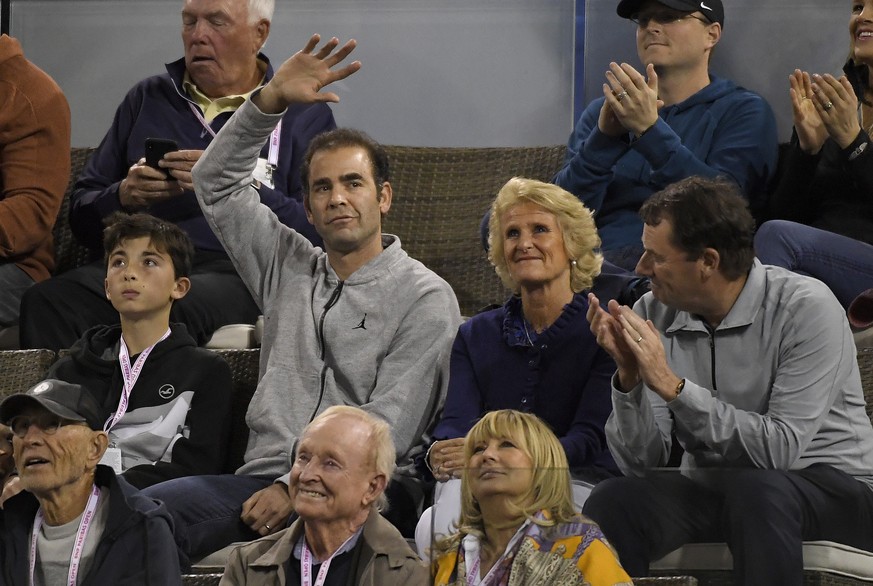 Former tennis player Pete Sampras, second from left, waves during a quarterfinal between Roger Federer, of Switzerland, and Chung Hyeon, of South Korea, at the BNP Paribas Open tennis tournament, Thur ...