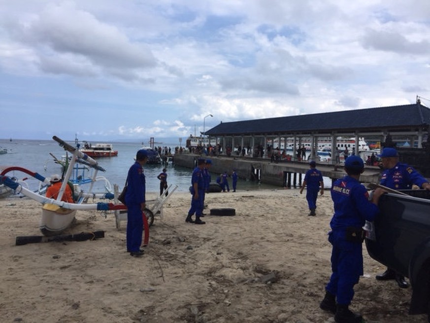 Police are seen at the port where a ferry carrying tourists to the nearby island of Lombok departed from in Padangbai, Bali Indonesia September 15, 2016. Handout via REUTERS ATTENTION EDITORS - THIS I ...