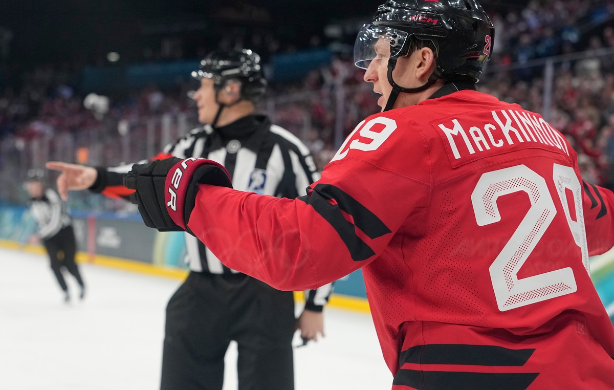 Canada's Nathan MacKinnon celebrates after scoring his sides fifth goal during a preliminary round match of men's ice hockey between Canada and Switzerland at the 2026 Winter Olympics, in Mi ...