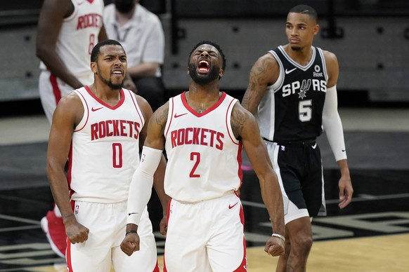 Houston Rockets guard Sterling Brown (0) and forward David Nwaba (2) celebrate their win over the San Antonio Spurs in an NBA basketball game in San Antonio, Thursday, Jan. 14, 2021. (AP Photo/Eric Ga ...