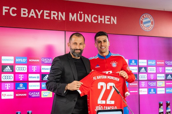 epa10441264 A handout photo made available by FC Bayern Muenchen of player Joao Cancelo (R) and the club&#039;s sports director Hasan Salihamidzic during his presentation as new loan signing of the Ge ...