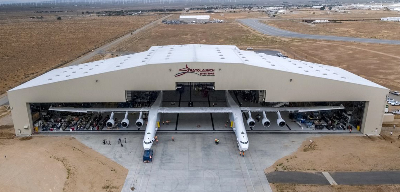 In this May 31, 2017 photo provided by Stratolaunch Systems Corp., the newly built Stratolaunch aircraft is moved out of its hangar for the first time in Mojave, Calif. The aircraft will undergo groun ...