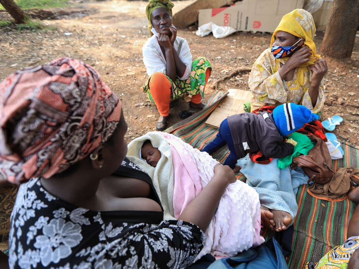 epa08496801 Women refugees from Rwanda and Burundi talk next to a footbridge where they sleep, ahead of World Refugee Day in Nairobi, Kenya, 19 June 2020. World Refugee Day is marked annually on 20 Ju ...