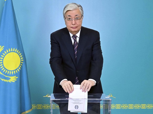In this photo released by the President Press Service of Kazakhstan, the President of Kazakhstan, Kassym-Jomart Tokayev, casts his ballot at a polling station in Astana, Kazakhstan, Sunday, March 19, 202…