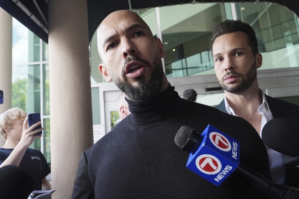 Influencer brothers Andrew and Tristan Tate arrive, Thursday, Feb. 27, 2025, in Fort Lauderdale, Fla. The brothers were charged with human trafficking in Romania and arrived in the U.S. after authorit ...