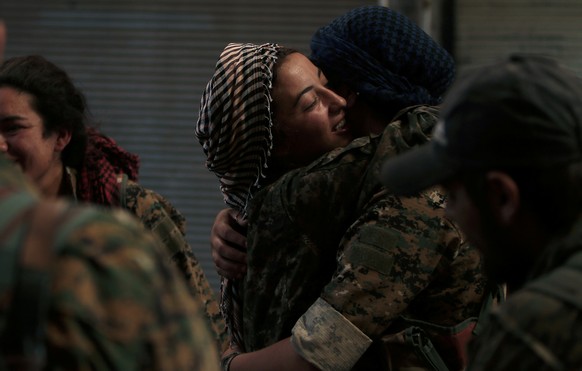 Syria Democratic Forces (SDF) female fighters embrace each other in the city of Manbij, in Aleppo Governorate, Syria, August 10, 2016. REUTERS/Rodi Said/File Photo
