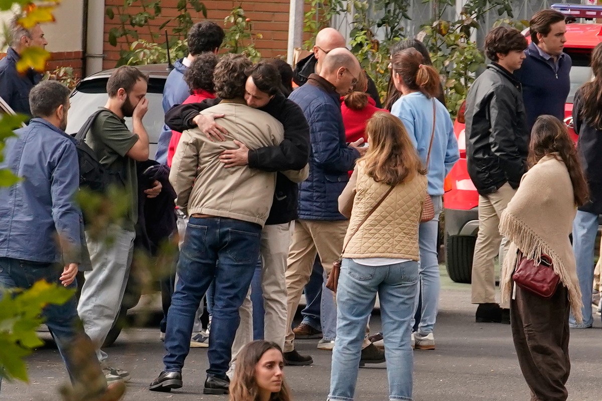 People searching for relatives who were traveling on the trains involved in a collision gather at a religious residence converted into a temporary medical facility in Toledo, Spain, Thursday, Oct. 29, ...