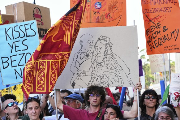 Activists stage a protest in Venice, Italy, Saturday, June 28, 2025, denouncing the three-day celebrations for the wedding between Jeff Bezos and his wife Lauren Sanchez Bezos that took place in Venic ...