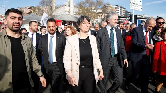 Newly elected Uskudar Mayor Sinem Dedetas, accompanied by her husband Baris Dedetas, walks at Uskudar Square after receiving her mayoral certificate, in Istanbul, Turkey April 4, 2024. REUTERS/Dilara  ...