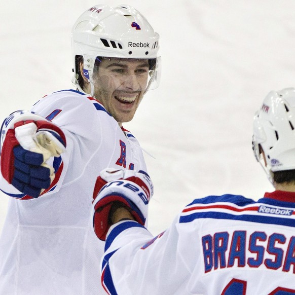 New York Rangers Raphael Diaz (4) and Derick Brassard (16) celebrate a goal against the Edmonton Oilers during second period NHL hockey action in Edmonton, Alberta, on Sunday March 30, 2014. (AP Photo ...