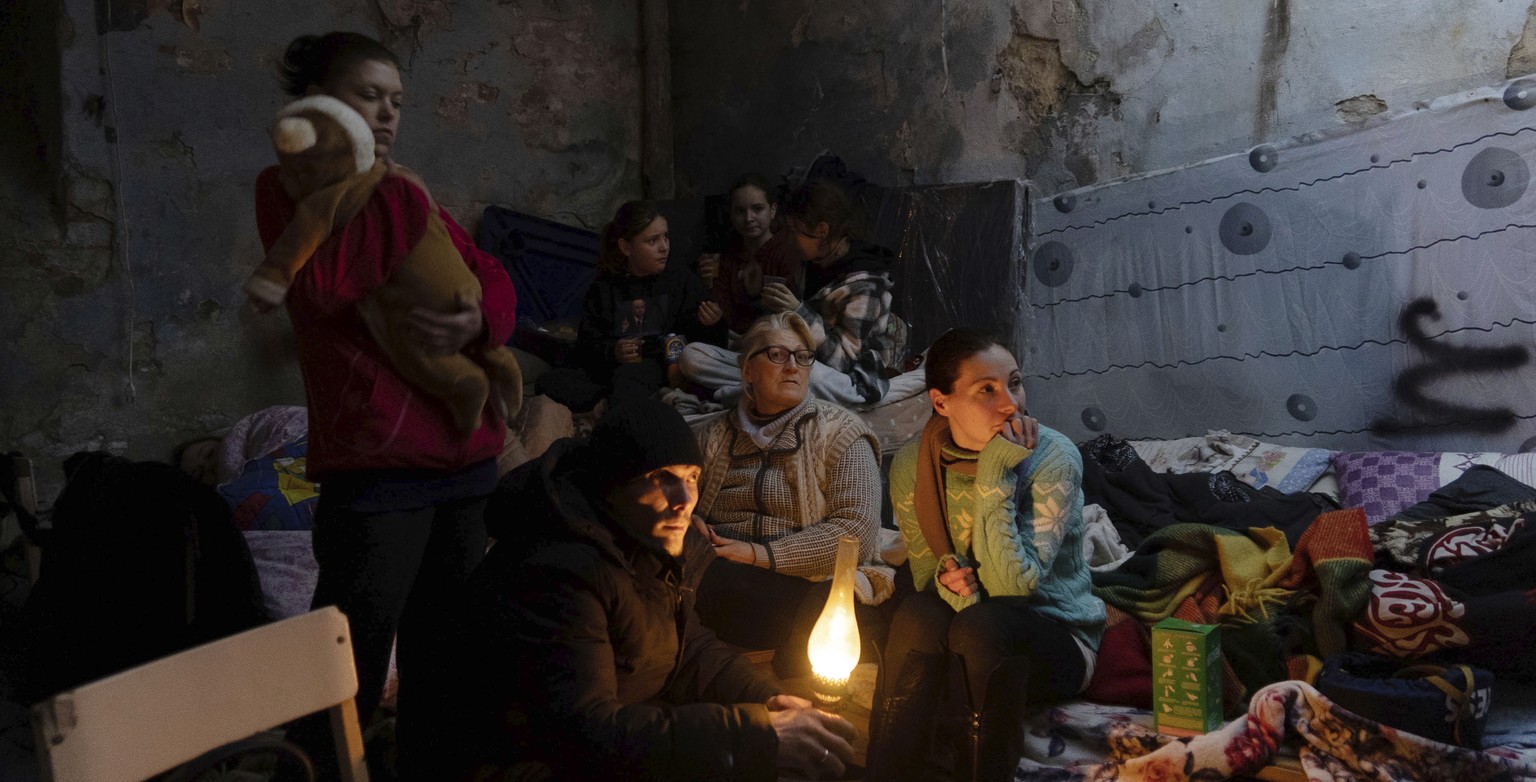 People settle in a bomb shelter in Mariupol, Ukraine, Sunday, March 6, 2022. (AP Photo/Evgeniy Maloletka)