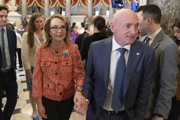 Sen. Mark Kelly, D-Ariz., accompanied by his wife Gabby Giffords, walk to the House chamber before President Joe Biden&#039;s State of the Union address at the U.S. Capitol, Thursday, March 7, 2024, i ...
