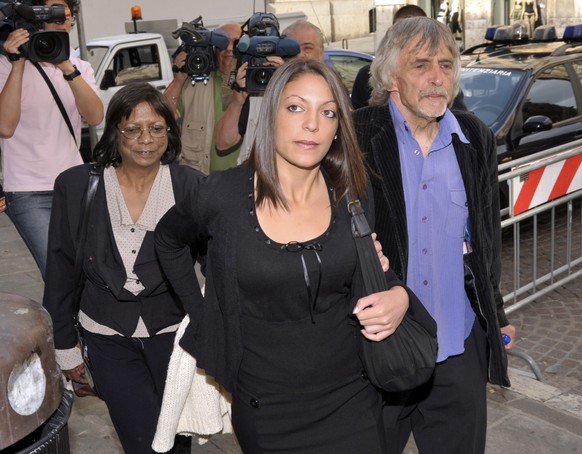 FILE - In this Saturday, June 6, 2009 file photo, Stephanie Kercher, center, sister of late Meredith Kercher, her mother Arline, left, and her father John arrive for a hearing in the Meredith Kercher  ...