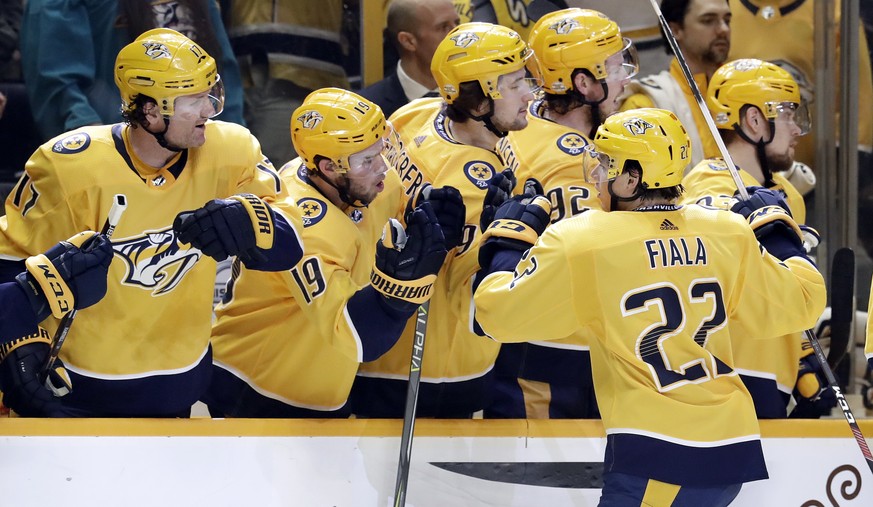 Nashville Predators left wing Kevin Fiala (22), of Switzerland, is congratulated after scoring against the St. Louis Blues in the first period of an NHL hockey game Sunday, Feb. 25, 2018, in Nashville ...