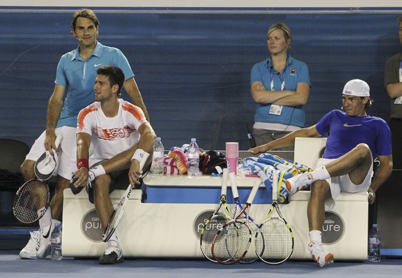 FILE - Roger Federer of Switzerland, left, Novak Djokovic of Serbia, second left, and Rafael Nadal of Spain watch an exhibition tennis match in Melbourne, Australia, in this Sunday Jan. 17, 2010, file ...