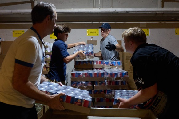 epa12479972 Cans of donated food are stacked for storage by volunteers until it can be transported to the North Hollywood Interfaith Food Pantry in Los Angeles, California, USA, 24 October 2025. Sever ...