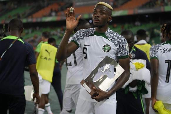 Nigeria&#039;s Victor Osimhen celebrates with his man of the match award after the African Cup of Nations Group A soccer match between Nigeria and Ivory Coast at the Stade Olympique Alassane Ouattara  ...