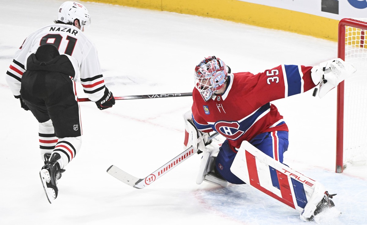 Chicago Blackhawks' Frank Nazar (91) scores against Montreal Canadiens goaltender Sam Montembeault, right, during shootout NHL hockey game action in Montreal, Monday, April 14, 2025. (Graham Hugh ...
