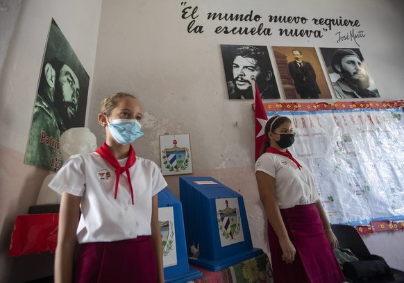 epa10206165 Young people in uniform guard a ballot box during the vote for the referendum on the new family code in Havana, Cuba, 25 September 2022. More than 16 percent of the almost 8.5 million Cuba ...