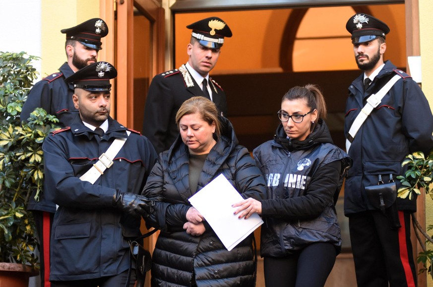 Maria Angela Di Trapani, center, is escorted by Italian Carabinieri, paramilitary Police officers, during an anti Mafia operation which led to the arrest of 25 people, in Palermo, Sicily, Italy, Tuesd ...