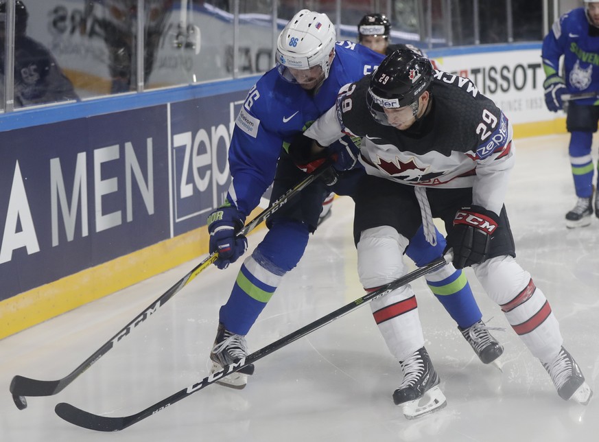 Canada&#039;s Nate Mackinnon, right, challenges Slovenia&#039;s Sabahudin Kovacevic, left, during the Ice Hockey World Championships group B match between France and Norway in the AccorHotels Arena in ...
