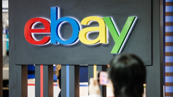 epa11588971 A visitor takes pictures in front of an Ebay logo during the opening day of the 100th IFA trade fair in Berlin, Germany, 06 September 2024. The IFA, the world's largest trade show for ...