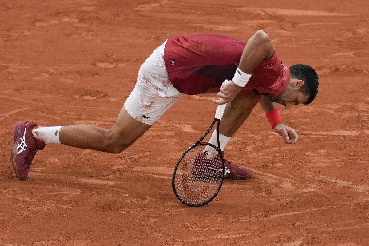 Serbia's Novak Djokovic slipped and fell during his fourth round match of the French Open tennis tournament against Argentina's Francisco Cerundolo at the Roland Garros stadium in Paris, Mon ...