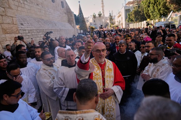 Latin Patriarch Pierbattista Pizzaballa, the top Catholic clergyman in the Holy Land, arrives at the Church of the Nativity, traditionally believed to be the birthplace of Jesus, on Christmas Eve, in  ...