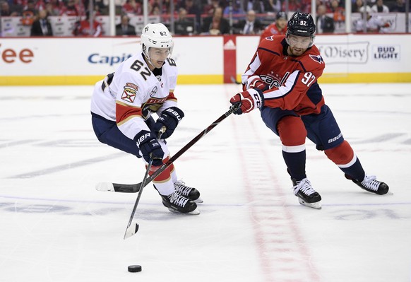 Washington Capitals center Evgeny Kuznetsov (92), of Russia, battles for the puck against Florida Panthers center Denis Malgin (62) during the third period of an NHL hockey game, Friday, Oct. 19, 2018 ...