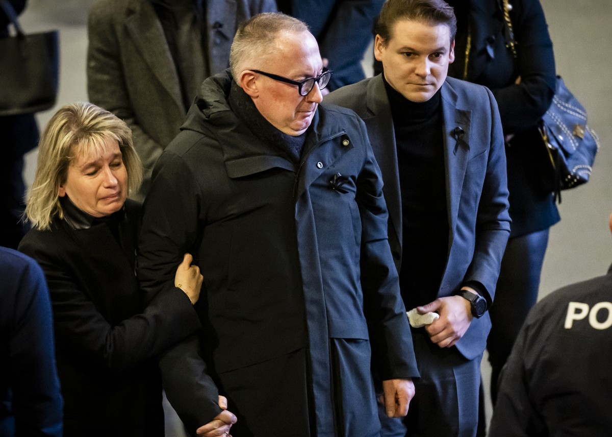Nicolas Feraud, Mayor of Crans-Montana reacts in memory of the victims as they watch on a screen in "Le Regent Congress hall" the official commemorative ceremony during the national day of m ...