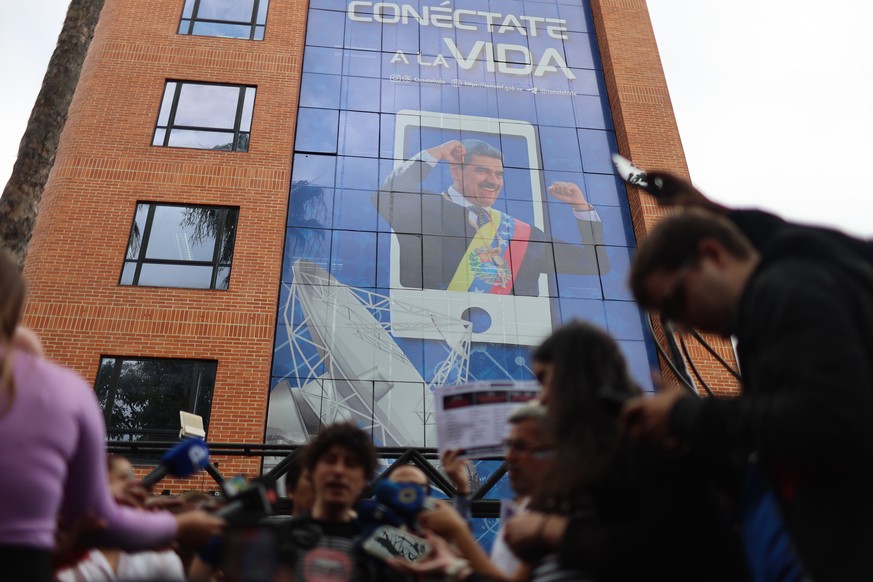 epa12817596 People gather for a protest in front of the building of Venezuela's National Telecommunications Commission (Conatel) in Caracas, Venezuela, 13 March 2026. Civil society organizations  ...