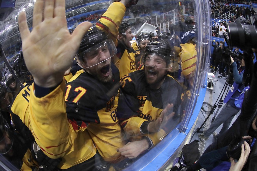 Germany players celebrate after the semifinal round of the men&#039;s hockey game against Canada at the 2018 Winter Olympics in Gangneung, South Korea, Friday, Feb. 23, 2018. Germany won 4-3. (AP Phot ...